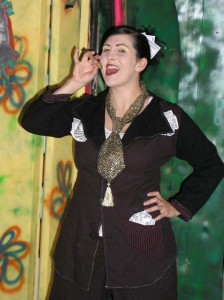 As Olivia Whorebucks in "Ann E. Wrecksick and the Odyssey of the Bulemic Orphans"